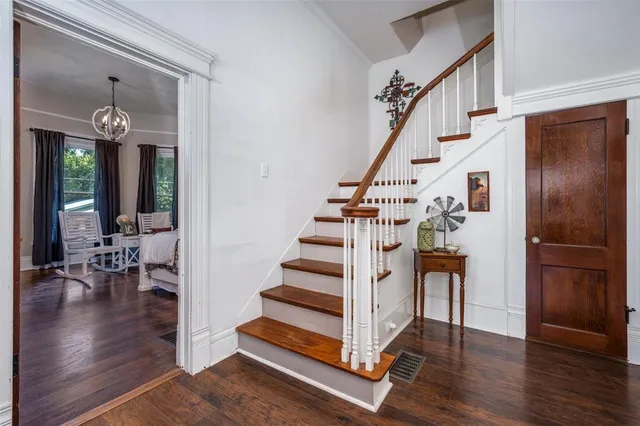 a view of entryway and hall with wooden floor