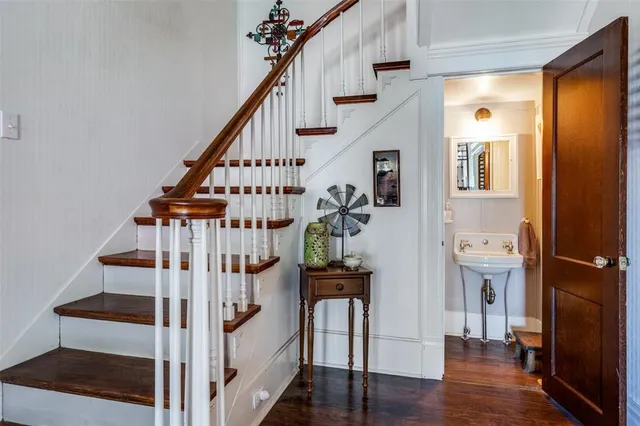 a view of a hallway with wooden floor and entryway