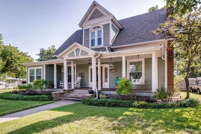a front view of a house with garden and porch