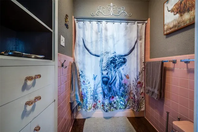a bathroom with a large mirror and a shower