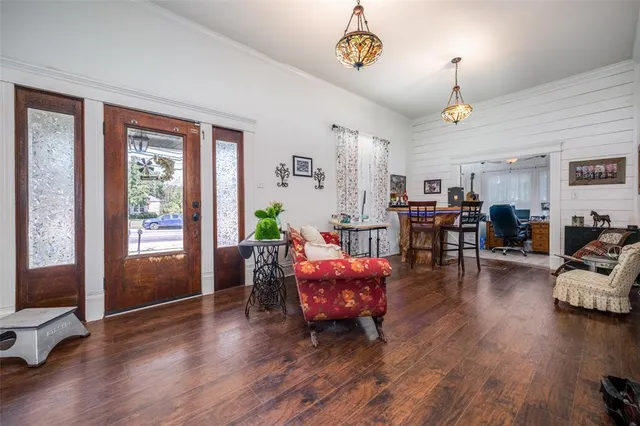 a living room with furniture and wooden floor
