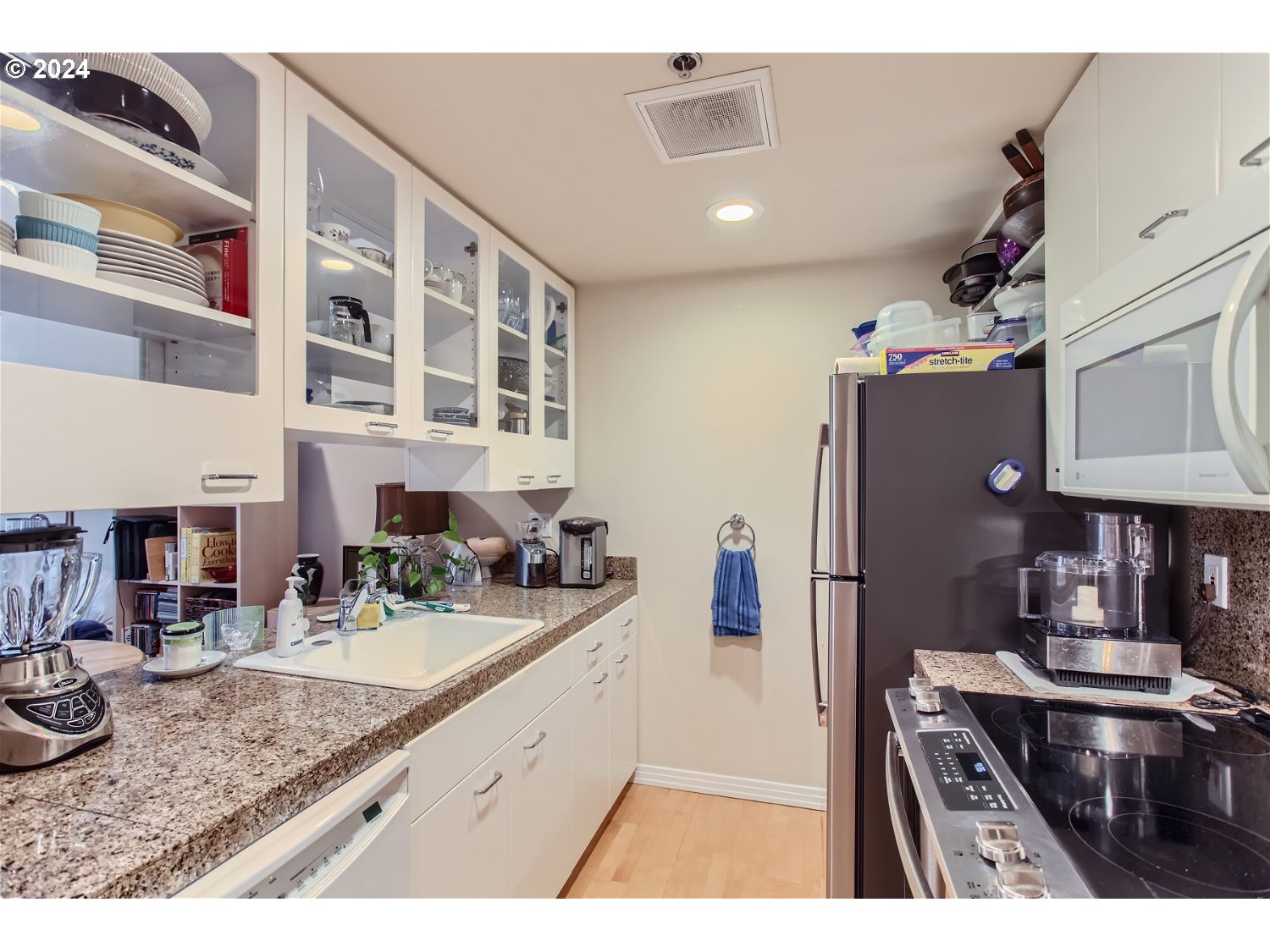 1132 Southwest 19th Avenue, Unit 309 Portland, OR 97205 - Photo 14 of 32 a kitchen with refrigerator and cabinets