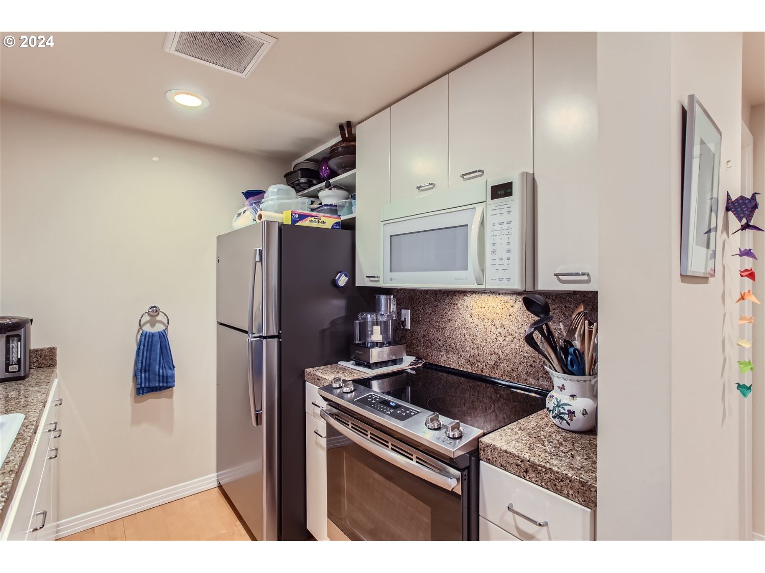1132 Southwest 19th Avenue, Unit 309 Portland, OR 97205 - Photo 15 of 32 a kitchen with a refrigerator and a stove