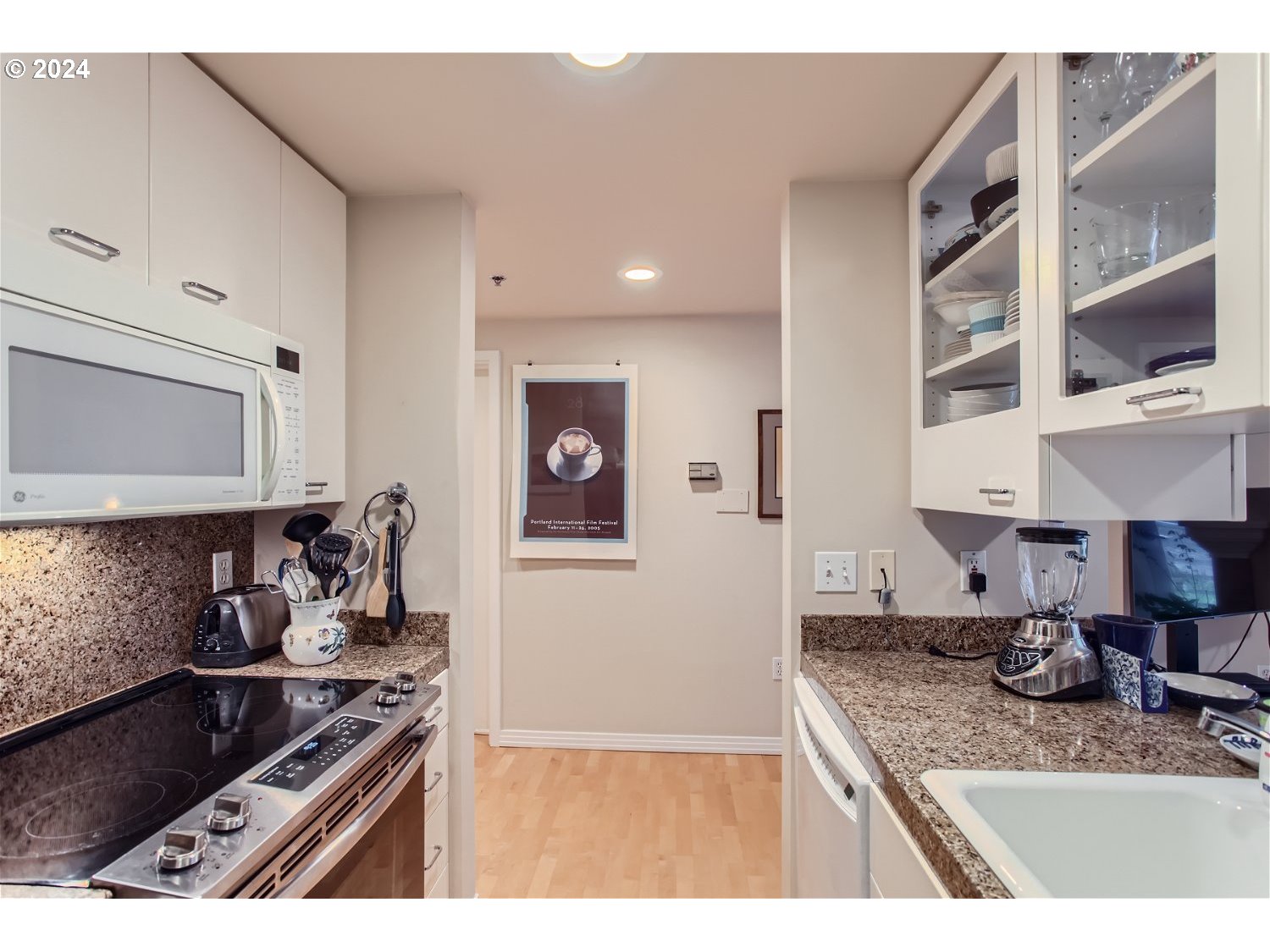 1132 Southwest 19th Avenue, Unit 309 Portland, OR 97205 - Photo 16 of 32 a kitchen with stainless steel appliances granite countertop a sink stove and cabinets