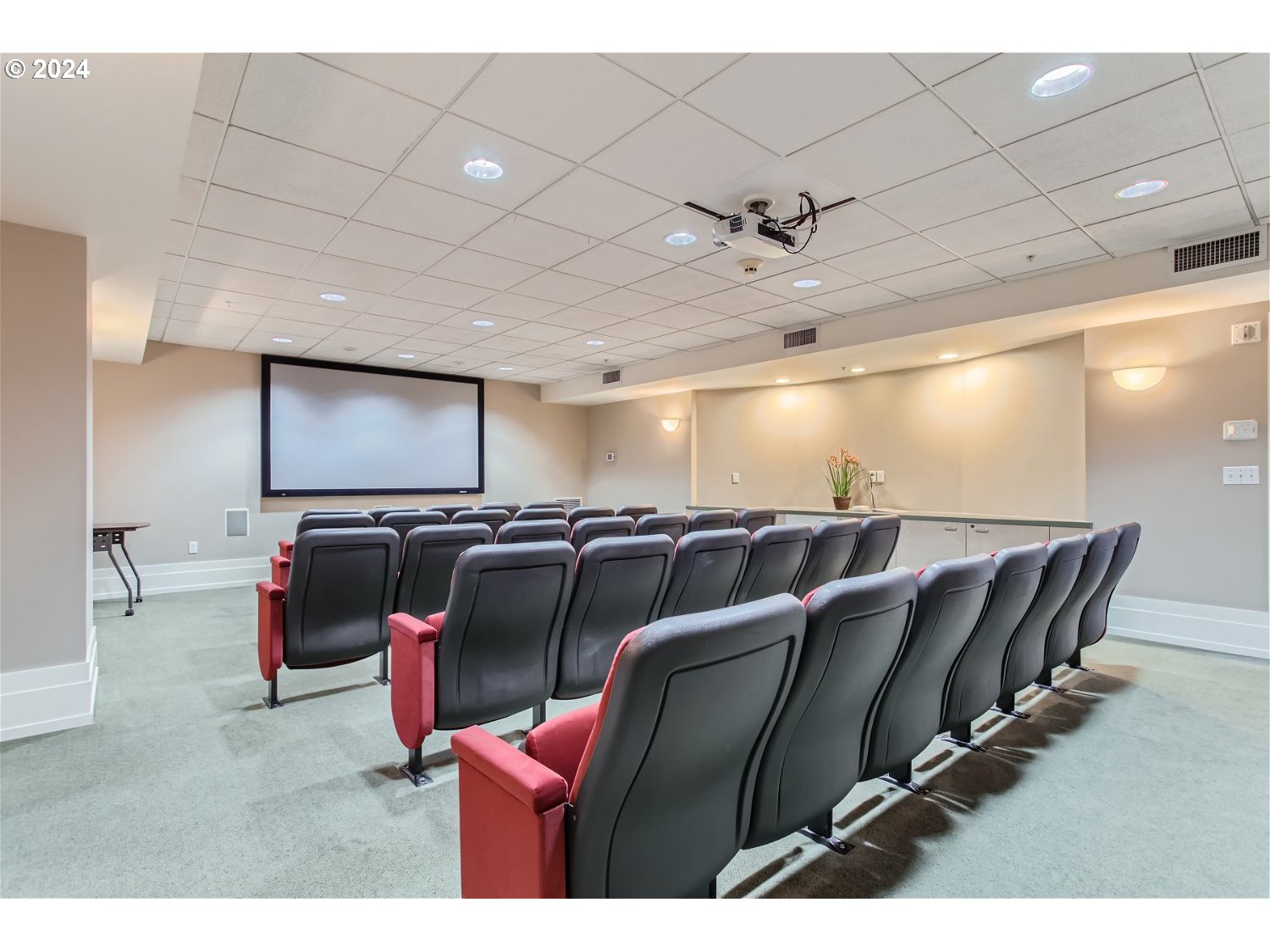 1132 Southwest 19th Avenue, Unit 309 Portland, OR 97205 - Photo 25 of 32 a media room with lots of chairs and a projector