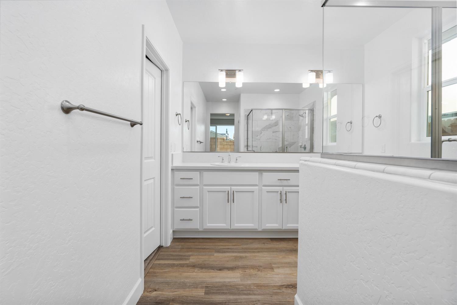 387 Peters Road Madera, CA 93636 - Photo 8 of 11 a bathroom with a sink a light fixture and a mirror