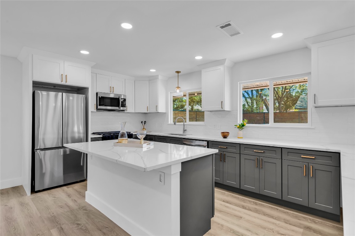11602 Big Trail Austin, TX 78759 - Photo 1 of 27 a kitchen with stainless steel appliances granite countertop a sink stove and refrigerator