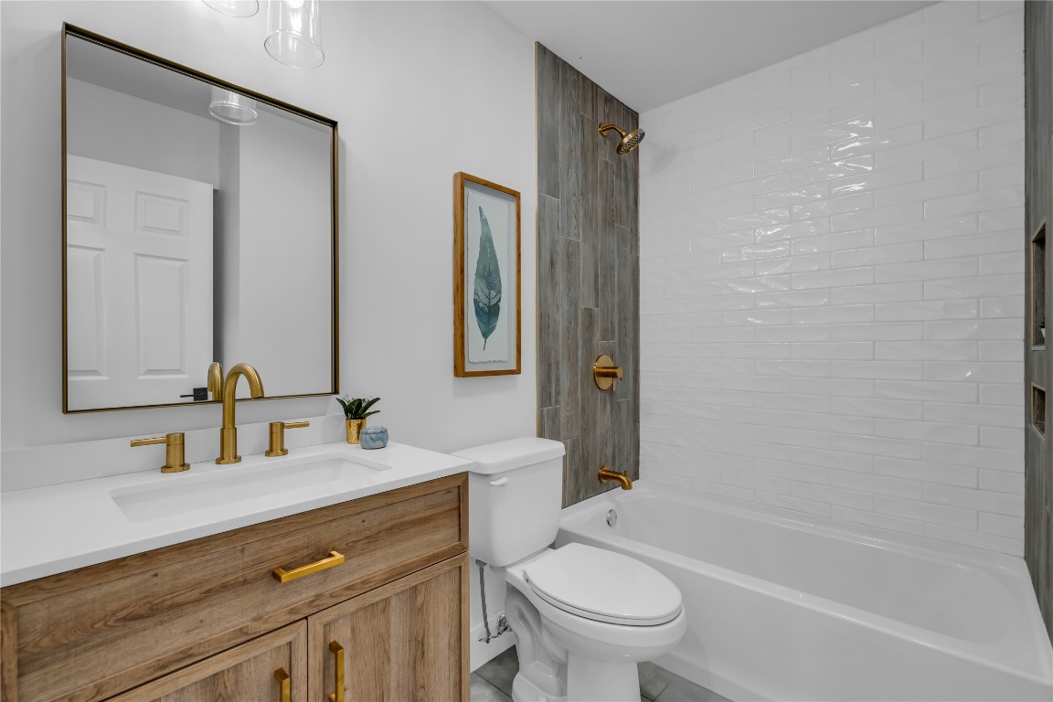 11602 Big Trail Austin, TX 78759 - Photo 12 of 27 a bathroom with a bathtub shower sink vanity mirror and toilet