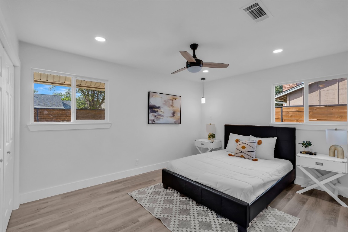 11602 Big Trail Austin, TX 78759 - Photo 15 of 27 a bedroom with a bed and wooden floor