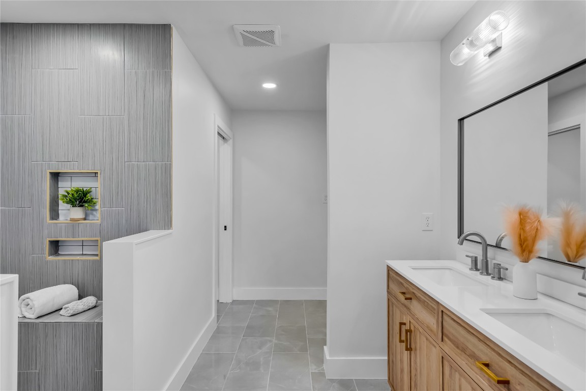11602 Big Trail Austin, TX 78759 - Photo 17 of 27 a bathroom with a sink and a mirror
