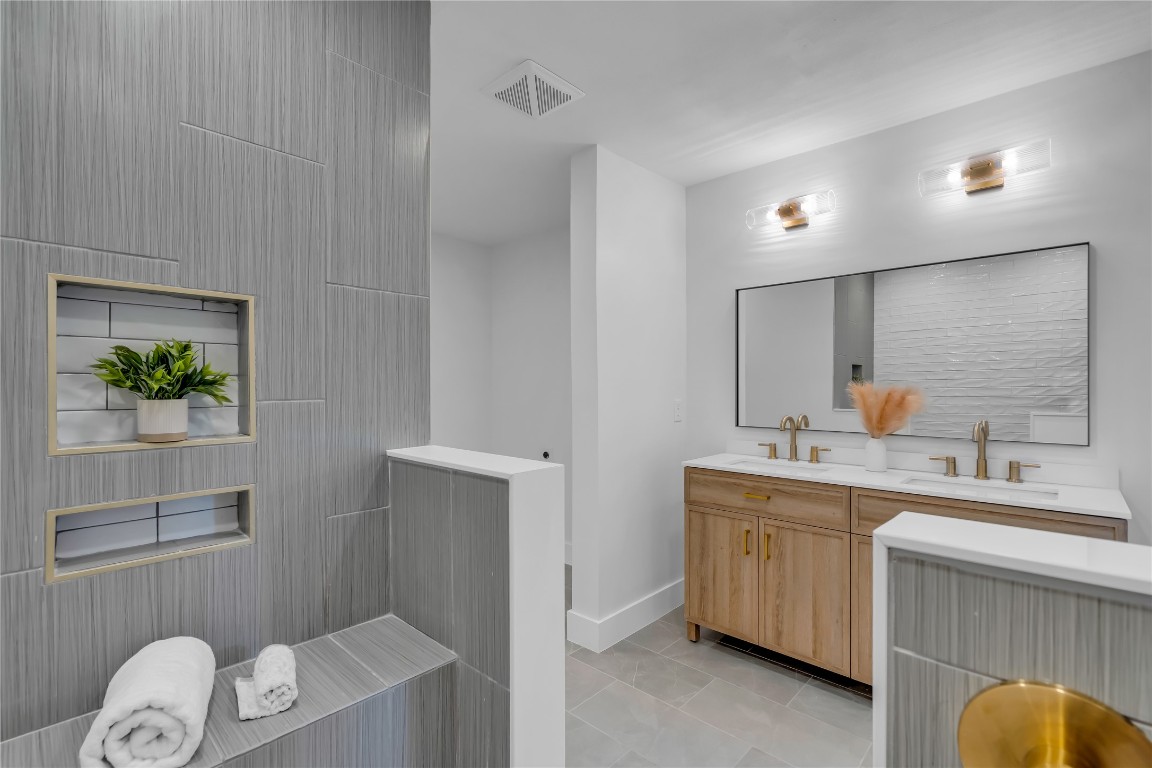 11602 Big Trail Austin, TX 78759 - Photo 18 of 27 a bathroom with a sink a light fixture a vanity and a toilet