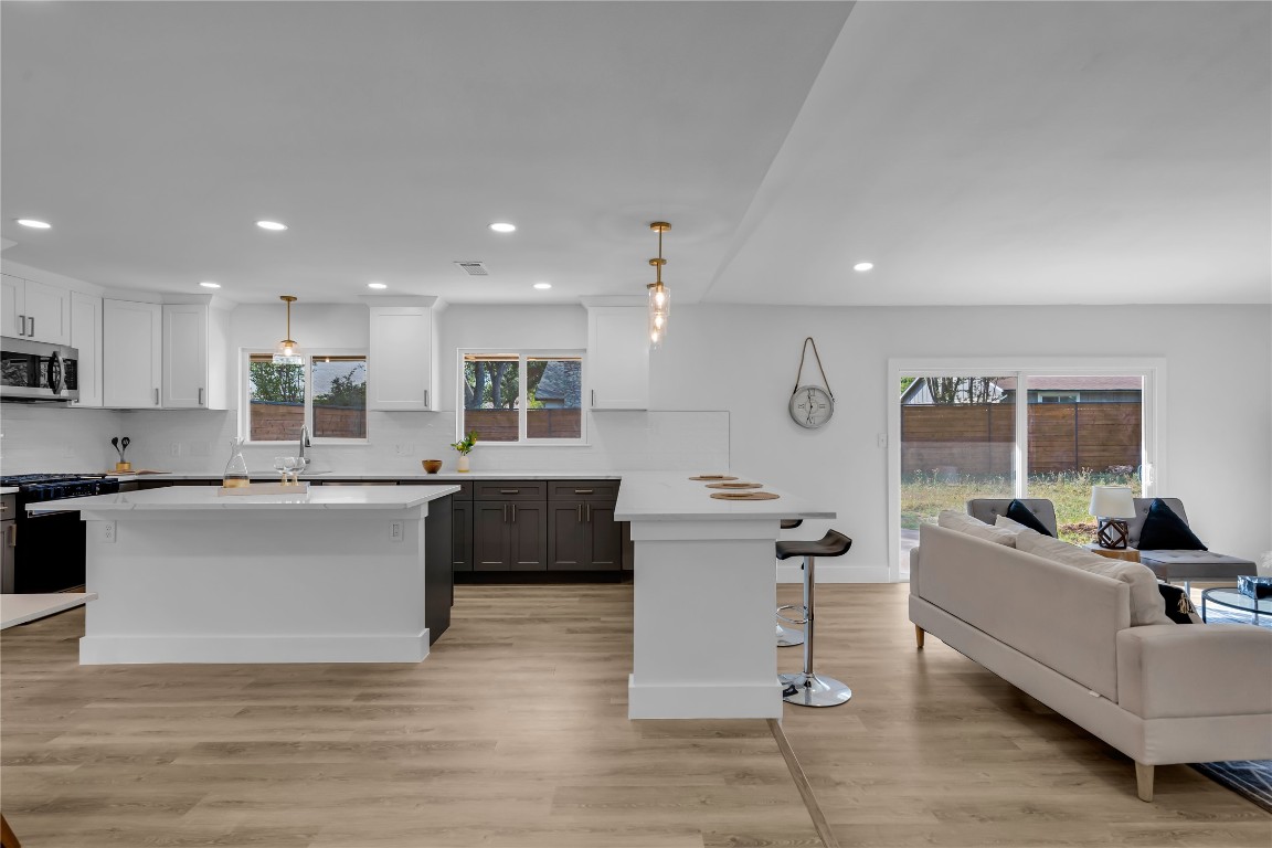 11602 Big Trail Austin, TX 78759 - Photo 27 of 27 a kitchen with a sink cabinets and wooden floor