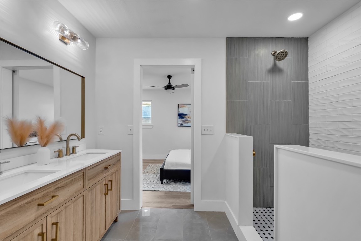 11602 Big Trail Austin, TX 78759 - Photo 20 of 27 a en suite bathroom with a double vanity sink and a mirror