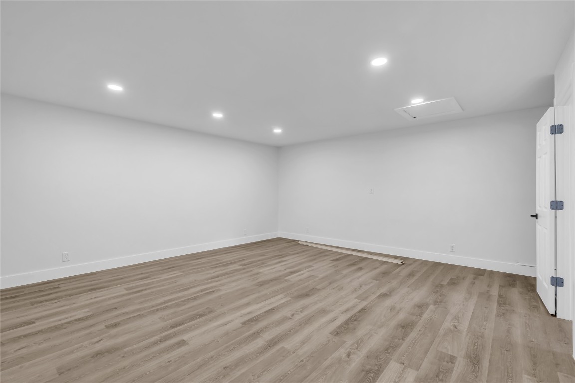 11602 Big Trail Austin, TX 78759 - Photo 23 of 27 an empty room with wooden floor and windows