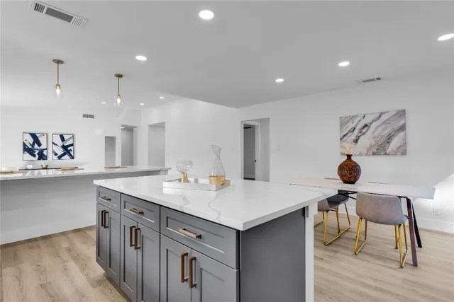 a kitchen with a sink a stove and cabinets