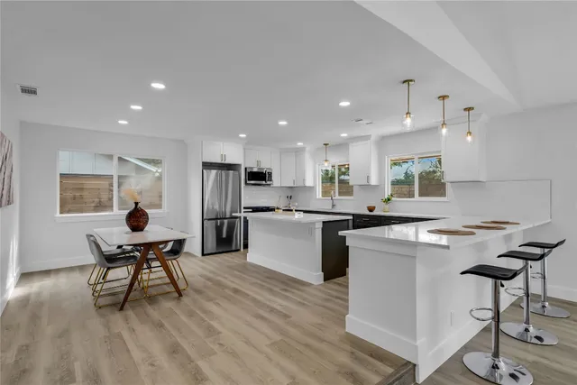 a kitchen with a table and chairs in it