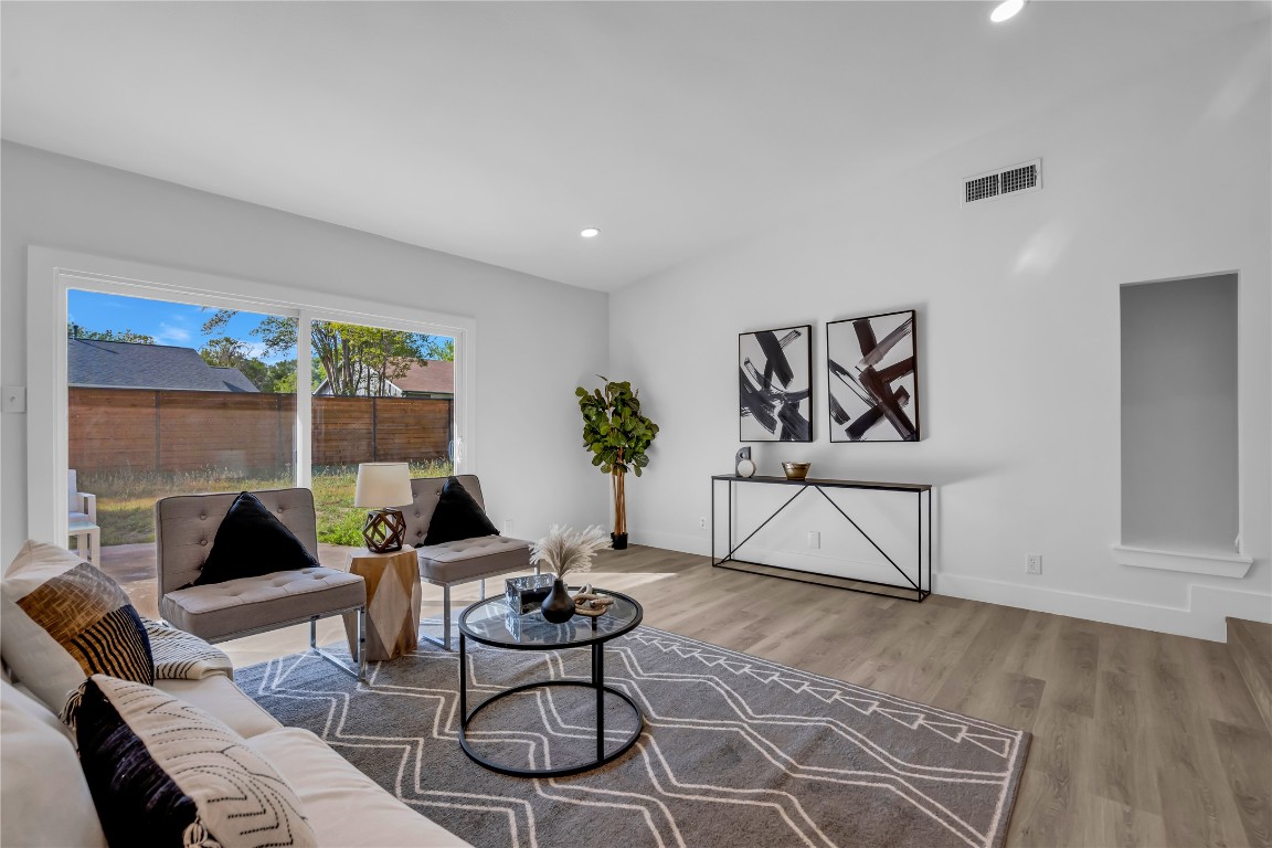 11602 Big Trail Austin, TX 78759 - Photo 8 of 27 a living room with furniture a rug and a floor to ceiling window