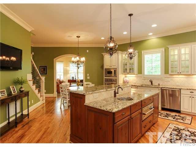 3112 Briar Stream Run Raleigh, NC 27612 - Photo 8 of 25 a large kitchen with kitchen island a sink a counter space appliances and living room view
