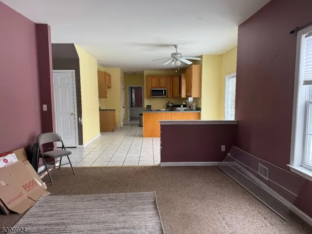 a room with a large window and gym equipment