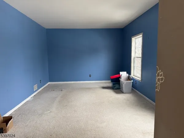 a view of a room with two windows