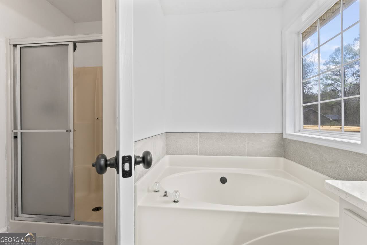 2093 Highway 36 Milner, GA 30257 - Photo 13 of 18 a bathroom with a tub