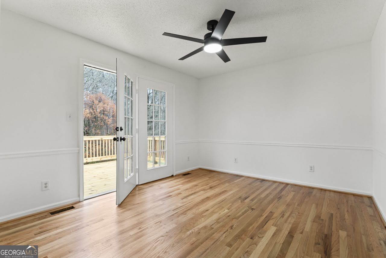 2093 Highway 36 Milner, GA 30257 - Photo 5 of 18 an empty room with wooden floor and windows