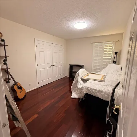 a bed sitting in a bedroom next to a window