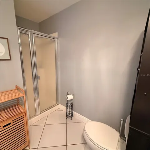 a white toilet sitting next to a shower