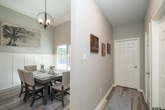 a view of a dining room with furniture and chandelier