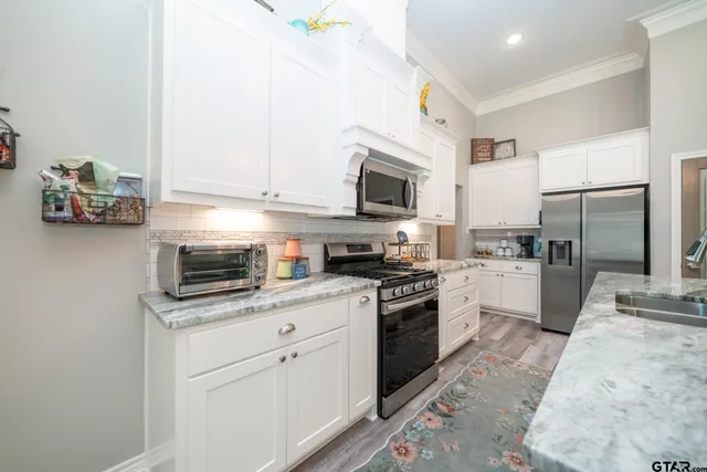 a kitchen with a sink stove and refrigerator
