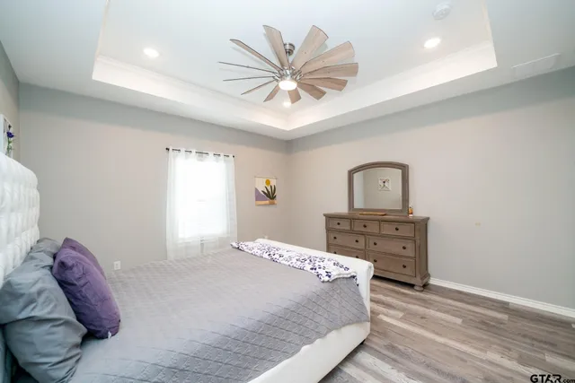a bedroom with a bed and ceiling fan