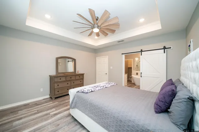 a bedroom with a bed and a chandelier