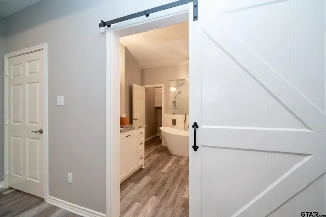 a spacious bathroom with a double vanity sink mirror and bathtub