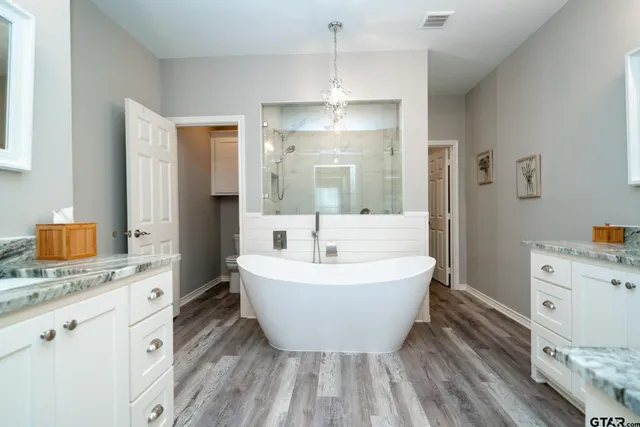 a bathroom with a toilet a sink and bathtub