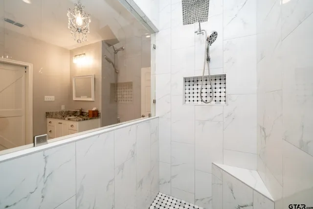 a spacious bathroom with a granite countertop sink and a mirror