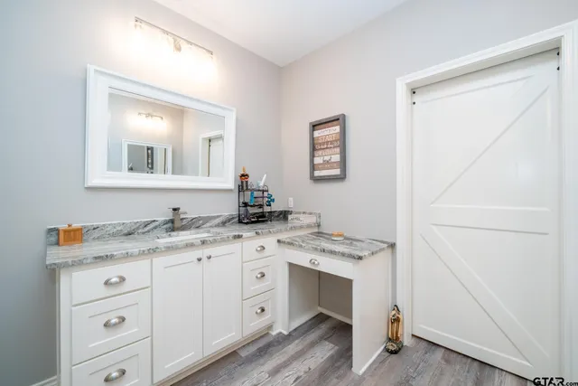 a room with a chandelier furniture and kitchen view