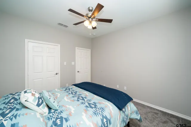 a bedroom with bed and window