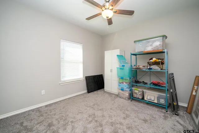 a view of room with window and ceiling fan
