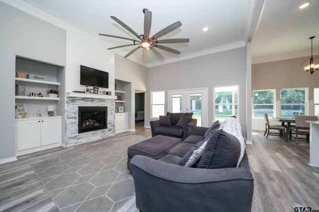 a living room with furniture a fireplace and a flat screen tv