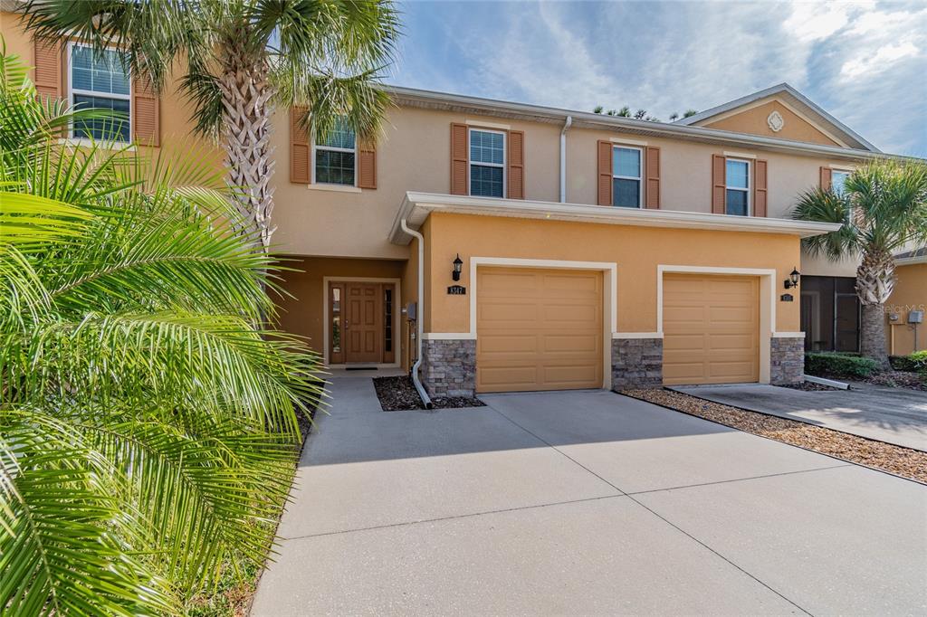 8347 Pine River Road Tampa, FL 33637 - Photo 1 of 1 a front view of a house with a yard and garage