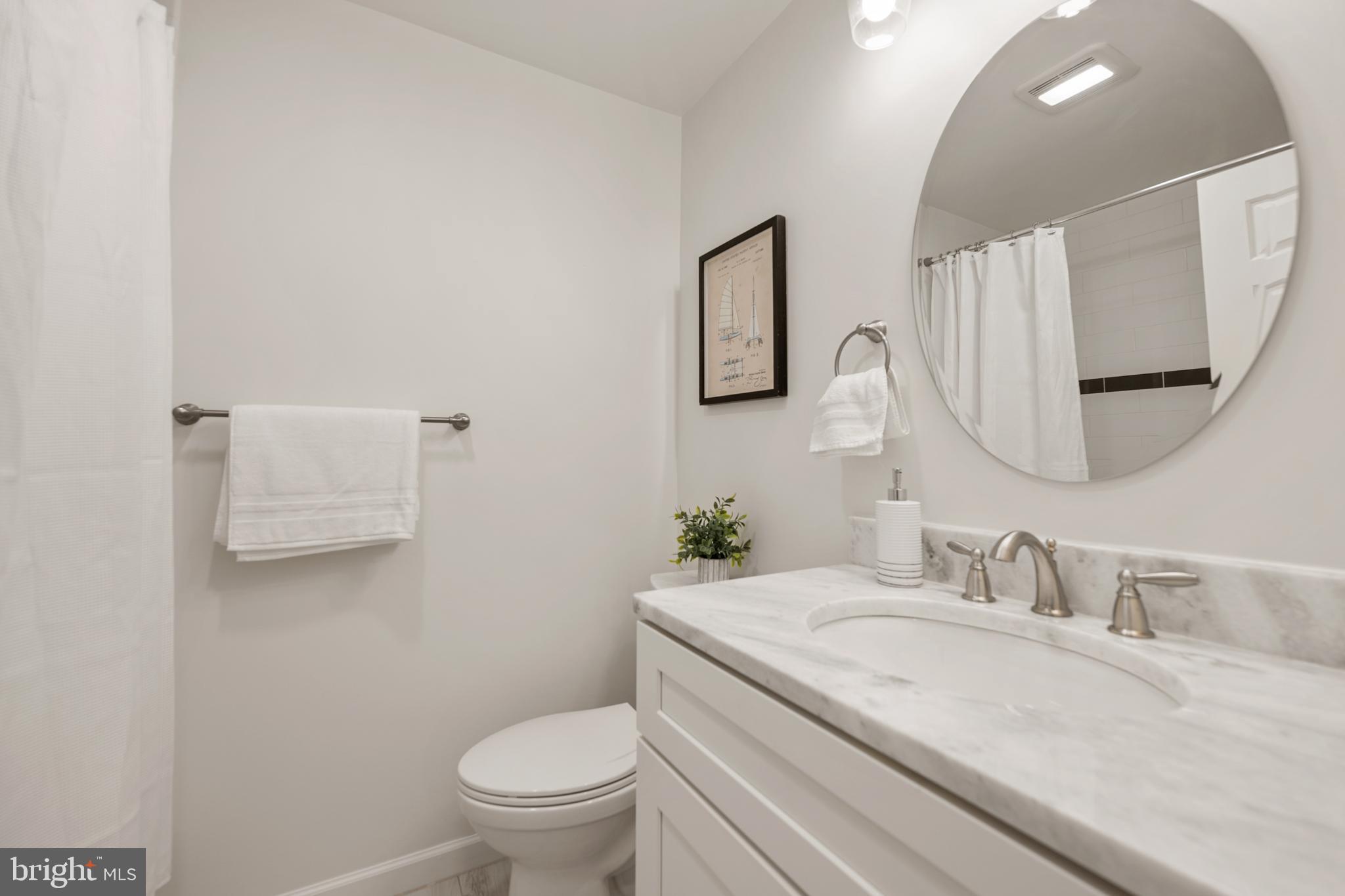 6800 Seton Court Springfield, VA 22152 - Photo 25 of 51 a bathroom with a granite countertop toilet sink and mirror
