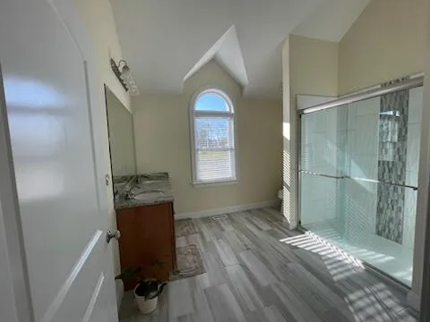 a bathroom with a bathtub and a window