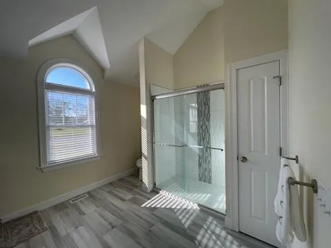 a spacious bedroom with a bed and a chandelier