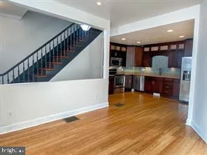 a view of a room with wooden floor and pool table