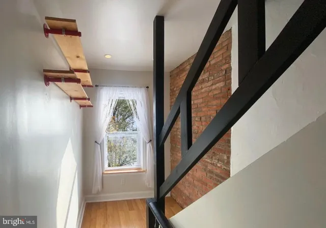 a view of entryway with wooden floor and stairs