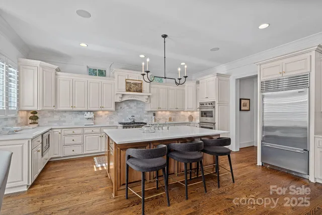 a kitchen with stainless steel appliances granite countertop a stove and a sink