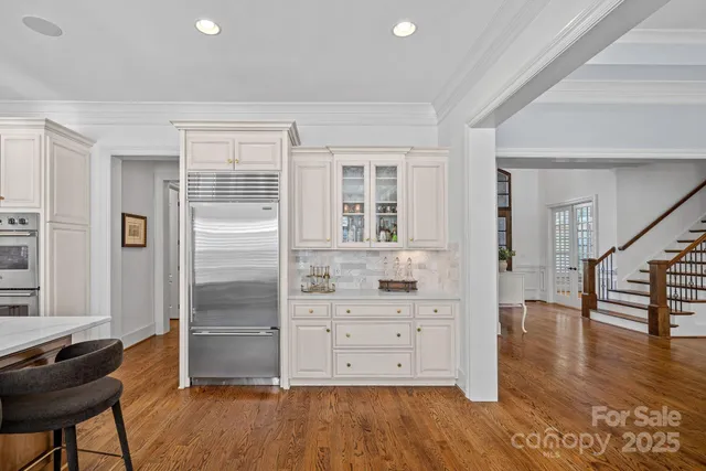 a kitchen with stainless steel appliances granite countertop a sink a oven and a center island