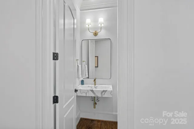 a spacious bathroom with a granite countertop sink and a mirror