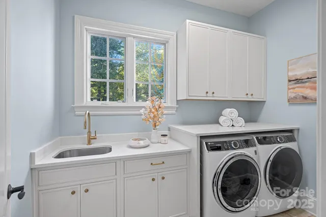 a white bath tub sitting in a bathroom next to a window