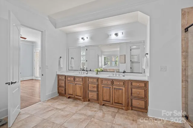 a view of a hallway with wooden floor and stairs